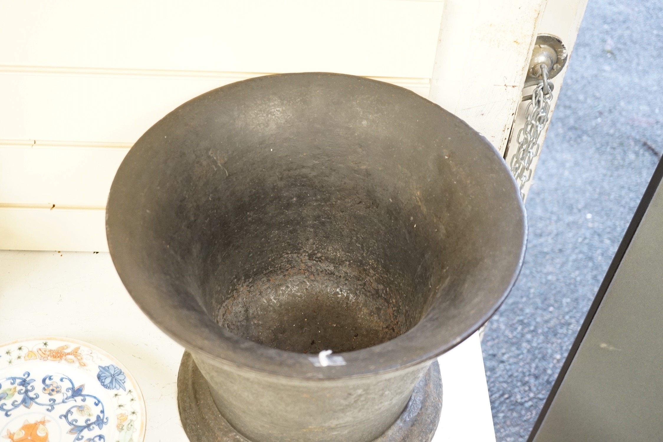 A large cast iron mortar Height 29 cm Width 36 cm